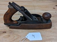 Side view of Stanley Rule & Level Co. No. 35 hand woodworking plane showing wooden rear handle, front knob, metal base and blade adjustment mechanism.