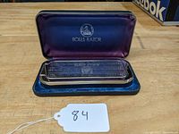 Open fitted case with visible purple lining and Rolls Razor logo. Razor and stropping mechanism inside.