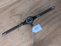 Full view of the vintage metal tap wrench with long handles and central adjustable die.