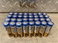 Front view of 32 GP Ultra Plus AA batteries arranged in four rows, showing battery tops.