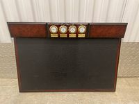 Full view of Bombay wooden desk board with four clocks and large black panel
