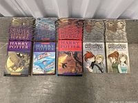 Set of three Harry Potter books with illustrated covers.