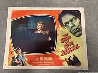 Full front view of the lobby card with the movie title, main scene, and monster image.