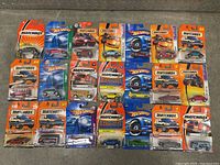Overview of all 31 vintage Hot Wheels and Matchbox cars in original packaging, showing a variety of collectible models.