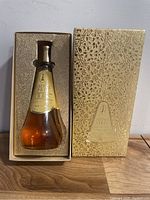 Full view showing the YRAM Essence Spray bottle inside original gold embossed box.