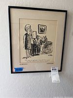 Photo of framed New Yorker cartoon print on wall with label showing 14x16 measurements and auction tag 959