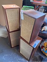 Four AR Inc wooden speakers stacked in two pairs, showing overall condition and grouping