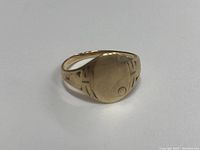 Photo of the ring top, showing the engraved cross and circle on the flattened oval face of the ring.