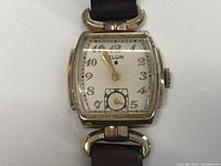 Front view of the Elgin Art Deco wristwatch showing rectangular gold-tone case, dial with Arabic numerals and small seconds subdial.