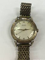 Front view of Gruen Precision wristwatch showing the dial, hands, and metal bracelet in used condition with visible wear and patina.