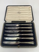 Six sterling silver butter knives in original Mappin and Webb presentation case.