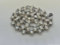 Close-up image showing the linked baroque freshwater pearls with sterling silver wire and chain.