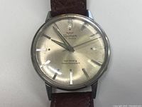 Close-up of the watch face showing Waltham branding, 17 Jewel indication, and text 'Self Winding Shock Resistant'. The dial is silver-toned with silver hour markers and hands, with visible wear and scratches on crystal and case.