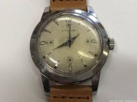 Front view close-up of the Wittnauer watch showing dial and case, with visible wear and scratches.