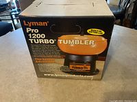 Photo of the unopened Lyman Pro 1200 Turbo tumbler box showing product branding and features.