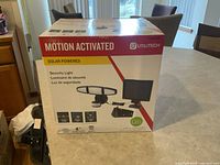 Sealed box showing the Utilitech solar powered motion-activated security light with product image and features on the box.