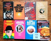 Front view of all eight paperback books arranged in two rows showing cover art and titles.