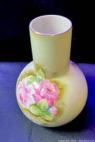 Lefton China vase with hand painted pink flower and green leaves on a light green background with gold rim detail.