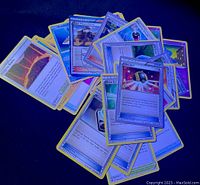 Spread of Pokémon trading cards showing different cards including Ultra Ball and others with colorful fronts and yellow borders.