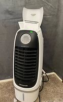 Honeywell portable air cooler with open top showing control dial and water level indicator at the bottom.