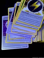 Close-up of various Pokémon Energy cards including Flash Energy showing card details and types.