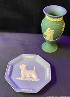 Small teal jasperware urn shaped vase with white classical figure and floral garlands reliefs alongside light blue octagonal jasperware dish with white Westie dog relief and floral accents.