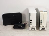 Oblique view of the two Emachines desktop computers alongside networking and power accessories.