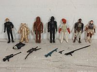 Full set of 7 vintage Star Wars Empire Strikes Back 3.75" action figures with accessories laid out in front of the figures.