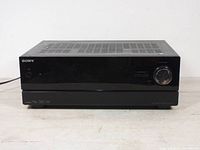 Front view of Sony STR-DN610 receiver showing closed front panel with volume knob and power button.