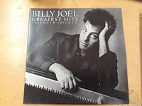Front cover of Billy Joel Greatest Hits LP record showing artist portrait and album title.