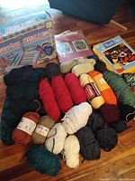 Full view of all items showing packed yarn skeins and balls in various colors along with the vintage weaving loom box, latch hook kit, and canvas art kit.