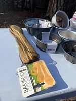 Bamboo cooking utensils in mesh pack with label reading Bamboo Cooking Utensils, including a spatula, slotted spoon, and spoon