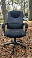 Front view of black office chair showing padded seat and contoured backrest with lumbar support
