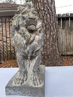 Front view of the composite lion statue showing detailed mane and upright posture on base.