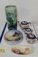 Full lot showing tall green florally painted vase, Japanese teapot set with sugar and creamer, Noritake and RS Germany bowls