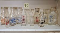 Front view of all eleven bottles lined up on shelf