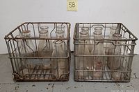 Both milk crates filled with glass bottles side by side