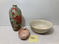 Full lot showing the pink candy dish, ceramic floral vase, and Lenox Fruits of Life bowl