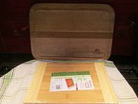 Photo of the two cutting boards showing new bamboo cutting board in packaging and Chicago Cutlery board behind