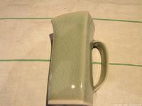 Top-down angled view showing the square shape, handle, and celadon crackle glaze detail