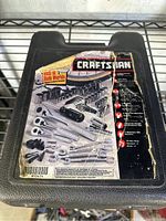 Black plastic carrying case for Craftsman hand tool kit showing label of tool contents and condition