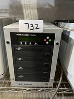 Front view of Disc Makers Reflex CD/DVD duplicator with 4 optical drives and LCD control panel.
