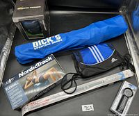Full lot overview showing all items including the fold chair bag, NordicTrack FlexBall box, Adidas gym bag, and Maxima pull-up bar