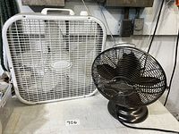 Image showing the white square box fan and the smaller antique-style metal desk fan side by side.