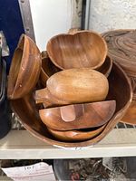 Wooden bowls stacked together inside a larger wooden bowl, different shapes and smooth finishes