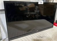 Front view of Vizio flat screen TV showing overall condition and screen
