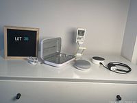 All items together on white dresser: Google Home Mini, Alexa smart speaker, UV sanitizer box, LED desk lamp
