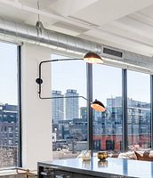 Fixture installed on wall with two swinging arm dome lights