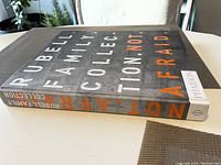 Side and spine view of the Rubell Family Collection book titled 'Not Afraid' showing the publisher Phaidon logo.