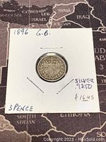 Front side of 1896 Great Britain 3 Pence silver coin showing denomination and crown.